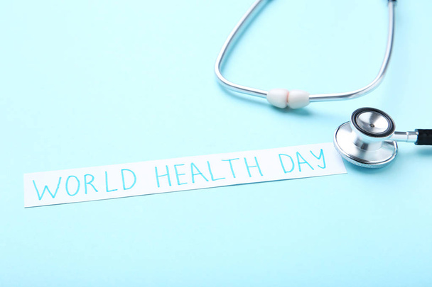 Text World Health Day with stethoscope on blue background - Фото, изображение