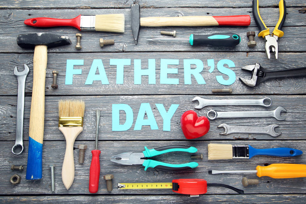 Inscription Fathers Day with different tools on wooden table - Valokuva, kuva