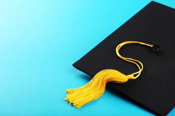 Graduation cap on blue background - Φωτογραφία, εικόνα