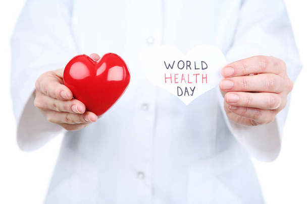 Paper with text World Health Day and red heart in female hands - Photo, Image