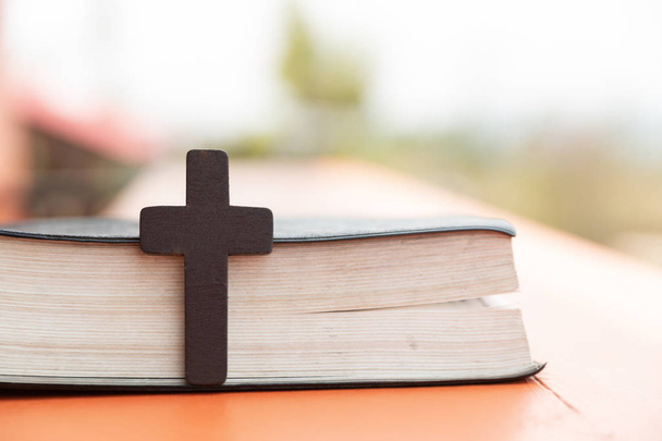 Κοντινό πλάνο του απλό ξύλινο χριστιανικού σταυρού στην Αγία Γραφή. Χριστιανική co - Φωτογραφία, εικόνα