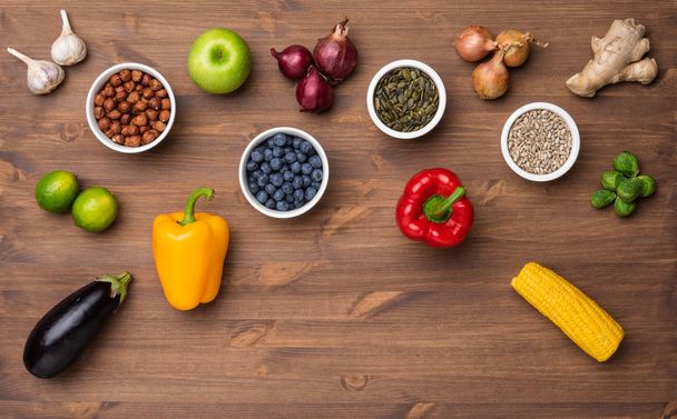 Healthy eating ingredients: fresh vegetables, fruits and superfood. Nutrition, diet, vegan food concept. Wooden background - Foto, Bild