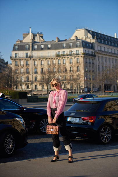 A trendy woman poses for street snaps during the Paris Fashion Week Womenswear Fall/Winter 2019/2020 street snap in Paris, France, 27 February 2019. - Zdjęcie, obraz