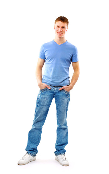 Young man standing with hands in pockets - Fotoğraf, Görsel
