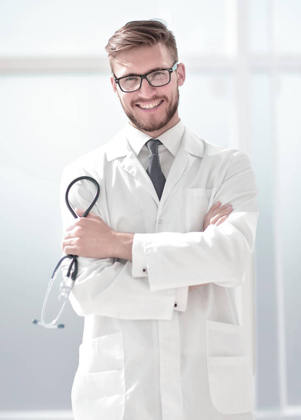 portrait of a smiling middle aged doctor in lab coat with stethoscope - Fotoğraf, Görsel