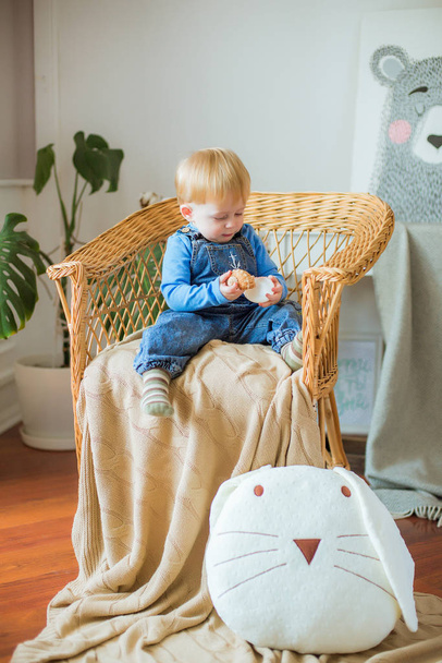 Little cute baby at home in the nursery plays with children's pillow toys - Fotoğraf, Görsel