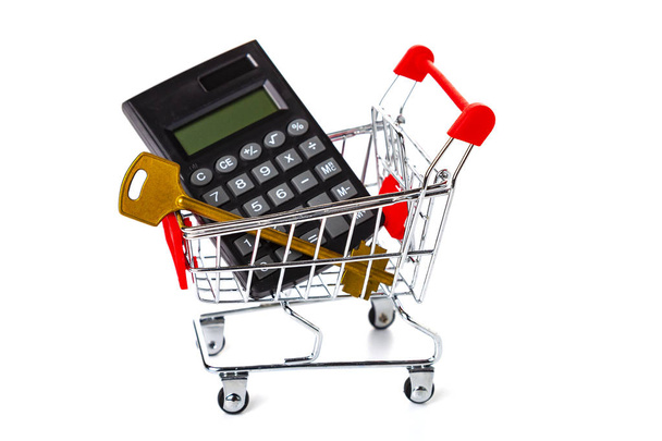 Shopping cart, key and calculator on white background - Foto, immagini