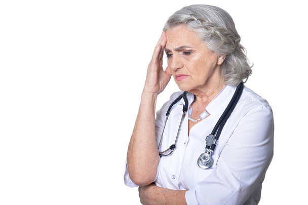 female senior  doctor  with headache on white background - Фото, зображення