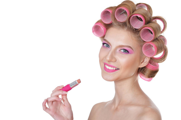 young woman applying lipstick - Фото, изображение