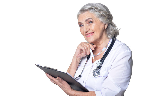 senior female  doctor with folder   on white background - Foto, Imagen