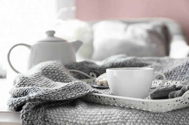 Tray with cup of hot tea on plaid - Фото, зображення
