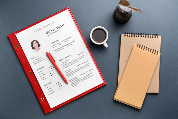 Job resume with notebooks and cup of coffee on grey background - Photo, Image