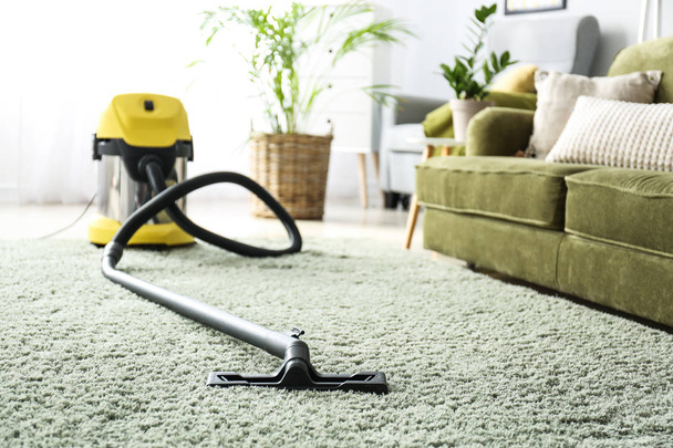 Vacuum cleaner on soft carpet in room - Photo, Image