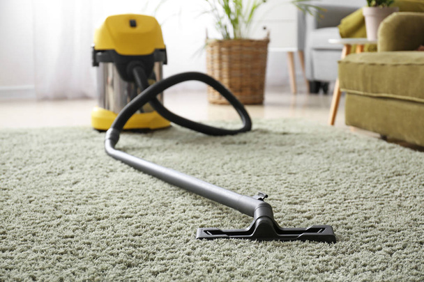 Vacuum cleaner on soft carpet in room - Photo, Image