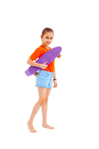 Girl with skateboard isolated on white background - Фото, изображение