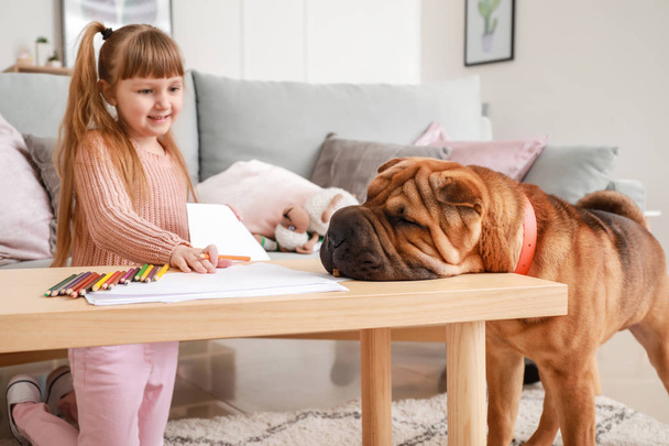 Cute little girl with funny dog at home - Photo, Image