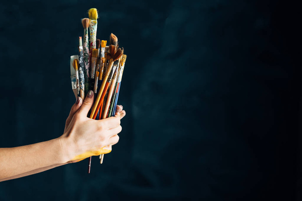 art supplies tools talent paintbrushes hands - Фото, изображение