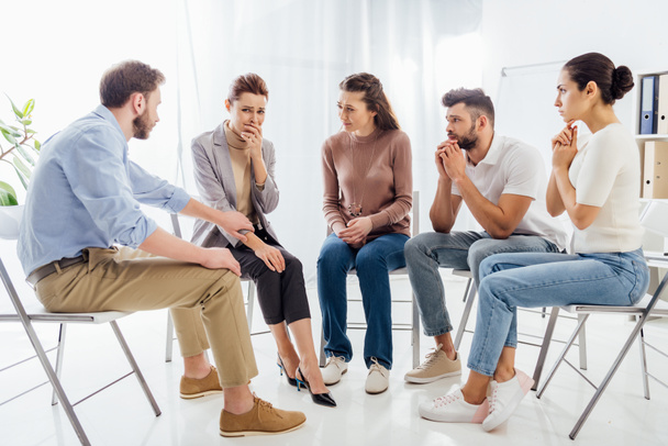 people sitting on chairs and having group therapy meeting - Photo, Image