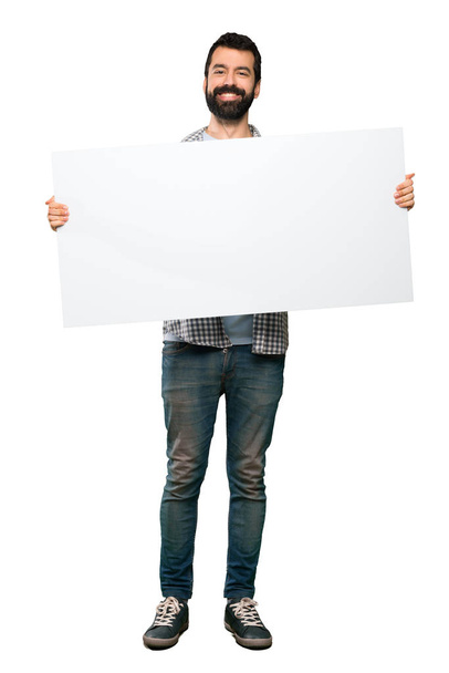 Happy Handsome man with beard holding an empty placard - Foto, imagen