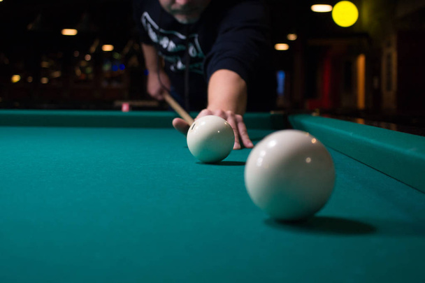 Russian billiard player aims to shoot ball with cue - Photo, Image