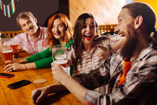 Best friends spending their Friday night in the pub drinking beer - Foto, Bild