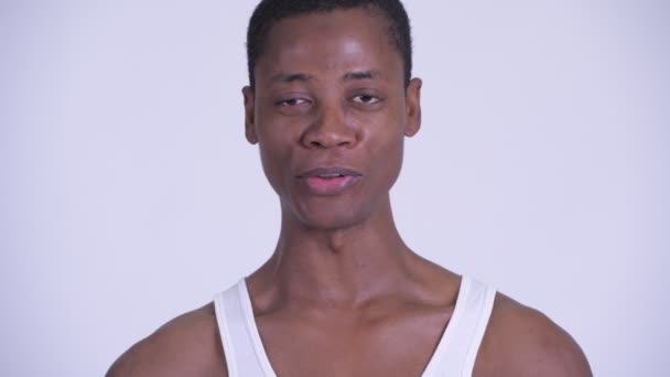 Face of young handsome African man being interviewed - Felvétel, videó