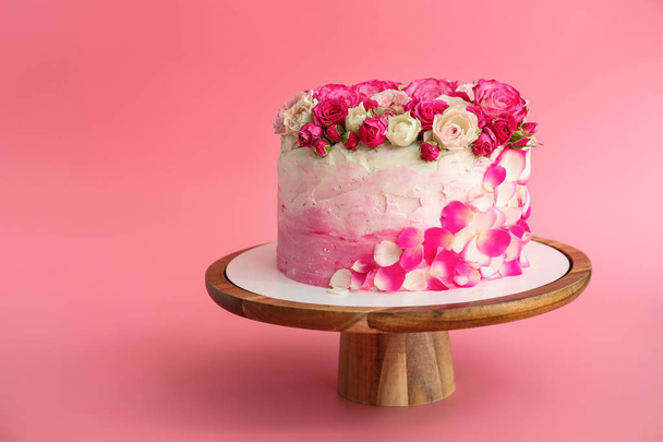 Stand with tasty Birthday cake on color background - Fotoğraf, Görsel