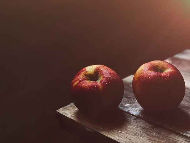 two ripe nectarines on wooden table edge - 写真・画像