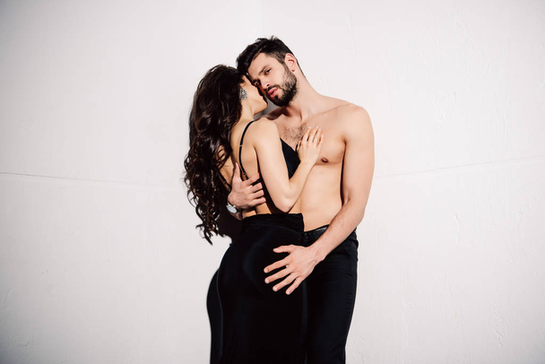 sexy brunette woman touching muscular handsome man on white - Valokuva, kuva