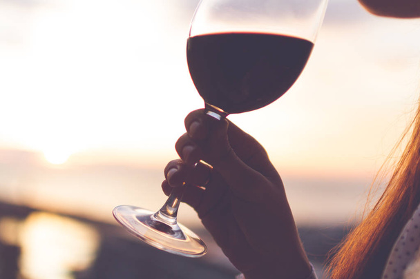 Relaxing and enjoying a glass of wine at sunset in the evening.  - Fotoğraf, Görsel