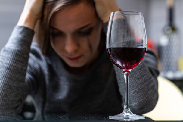 Depressed, divorced crying woman sitting alone in kitchen at hom - Zdjęcie, obraz