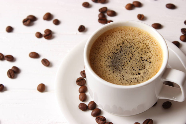 Cup of aromatic coffee and coffee beans on wooden background. Top view. Coffee drink - 写真・画像