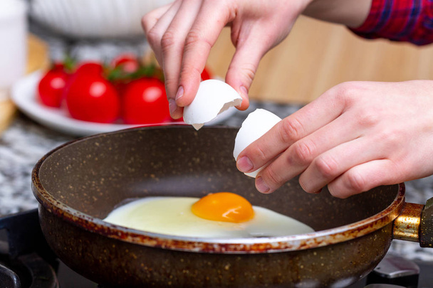Frying homemade, chicken eggs in the frying pan for a healthy  breakfast. Protein food  - Foto, Imagen