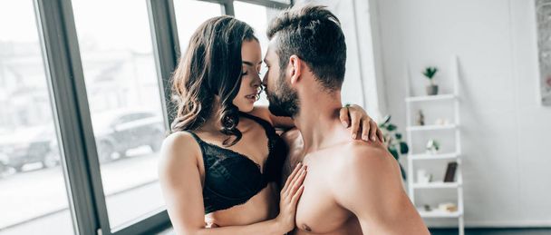 panoramic shot of shirtless bearded man looking at sexy woman with closed eyed - Photo, Image