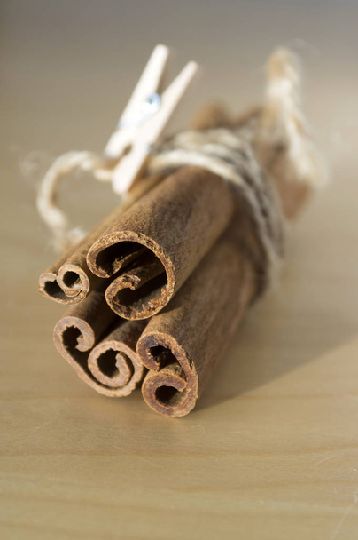 Cinnamon sticks on wooden table  - Фото, изображение