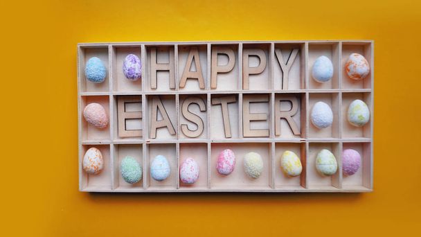 Easter eggs. Happy easter text. Holidays decoration orange background - Fotografie, Obrázek