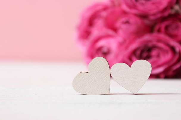 hearts on blurred background of flowers. Background to the day of Saint Valentine. - Zdjęcie, obraz