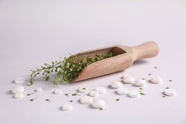 Scoop with herbs and pills on light background - Photo, Image