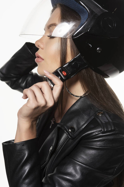 Beautiful young sexy biker girl, wearing a black leather jacket  - Photo, Image