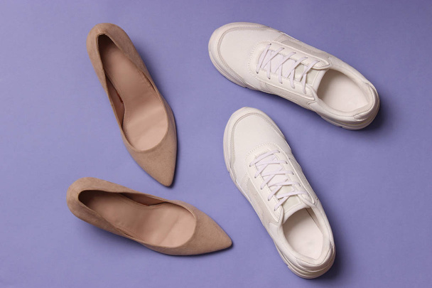 white sneakers and high heel shoes on a colored background top view. Women's shoes. Classic and sport shoes. - Photo, Image