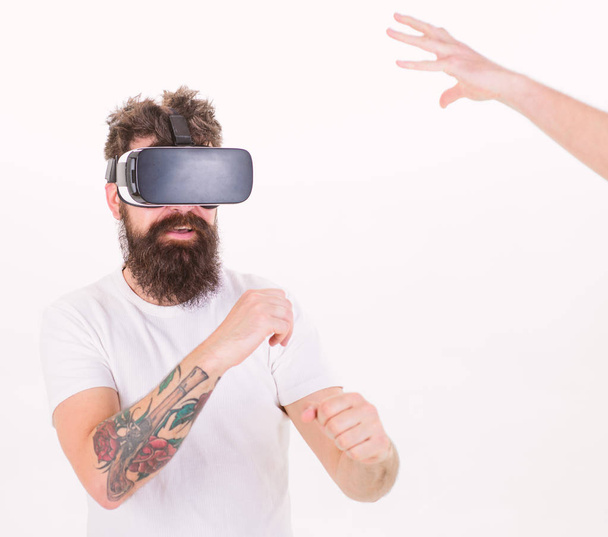 Man with stylish beard boxing with invisible opponent isolated on white background. Hipster with tattooed arm and beard checking new device. Bearded man enjoys 3D experience, virtual reality concept - Foto, Imagen