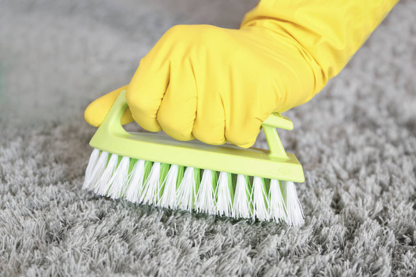 Woman cleaning carpet, closeup - Foto, Imagen