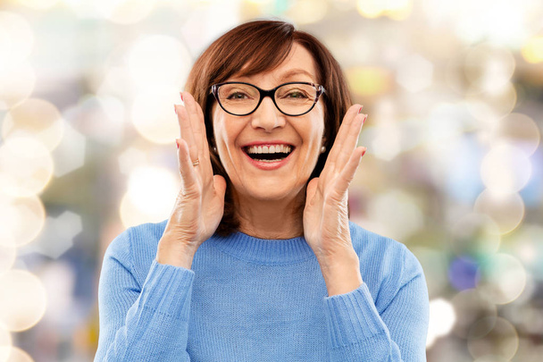 senior woman in glasses calling over grey - Foto, afbeelding
