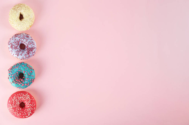 Minimal composition in vibrant colors with bright glaze donuts. - Φωτογραφία, εικόνα