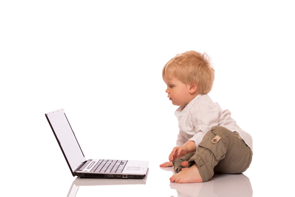 Young boy looking at a laptop - Foto, Imagen