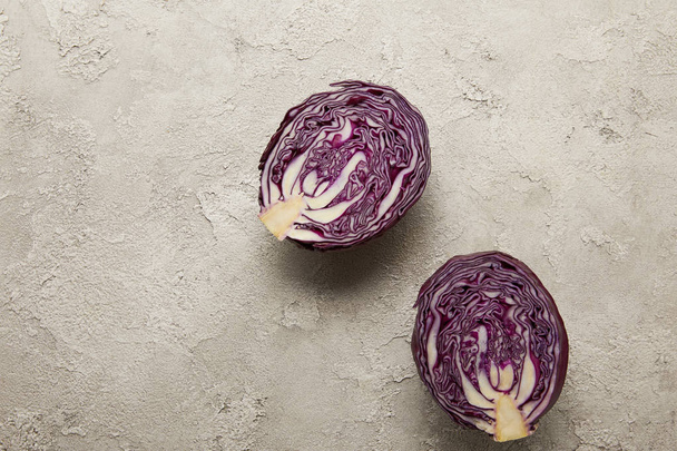 Top view of cut red cabbage on textured surface - Fotó, kép