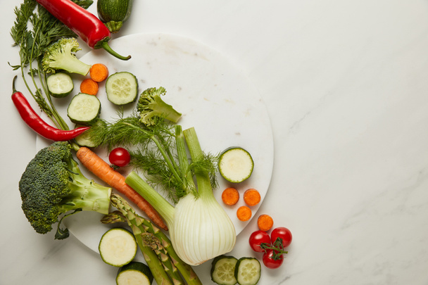 Flat lay with whole and cut vegetables on white surface - Photo, Image