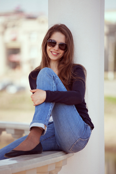 Charming woman in glasses and blue jeans - Φωτογραφία, εικόνα