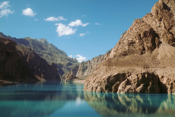 reflection in the water of Attabad Lake, surrounded by mountains in Karakoram range. Gojal Hunza, Gilgit Baltistan, Pakistan. - Foto, imagen