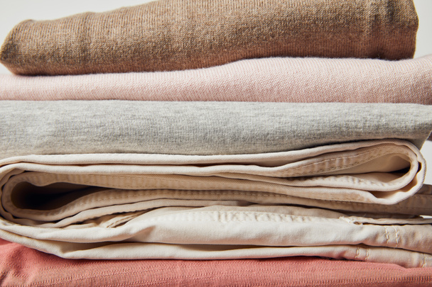 Close up view of stack of folded ironed clothes on grey - Fotografie, Obrázek